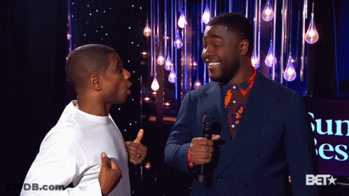 Two Men Standing With Bet Logo GIF