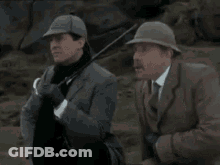 Two Men Standing With Blazing Talent Text GIF