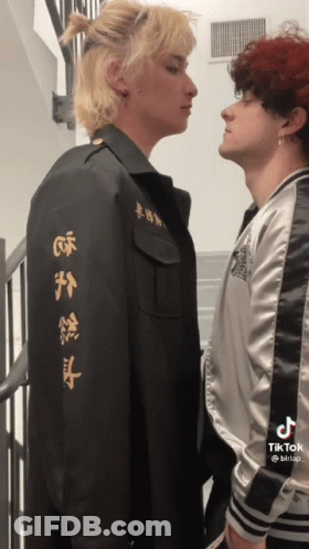 Two Men Standing With Chinese Writing Jacket GIF