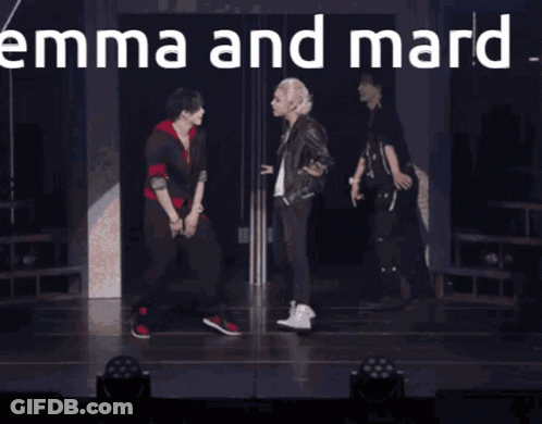 Two Men Standing With Emma And Mard GIF