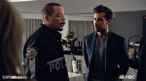 Two Men Standing With Police Patch GIF