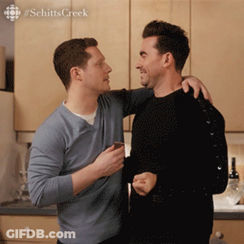 Two Men Standing With Schitts Creek GIF