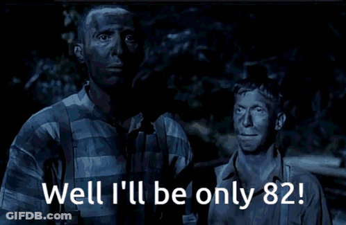 Two Men Standing With Well Ill Be Only 82 GIF