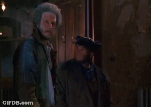 Two Men Standing With Words Never Behind GIF