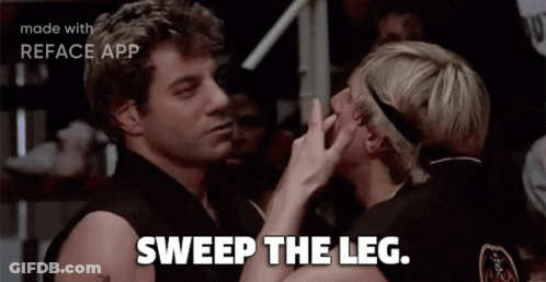 Two Men Sweep Each Other 'S Leg In A Movie Scene GIF