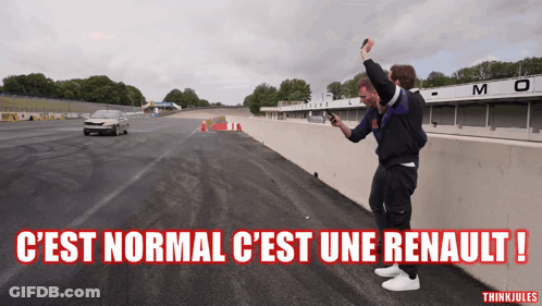 Two Men Taking Picture Of Car On Track C'est Normal C'est Une Renault GIF
