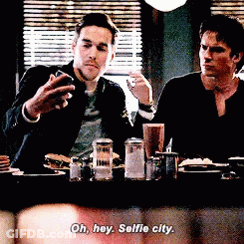 Two Men Taking Selfie At Diner Table GIF
