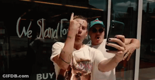 Two Men Taking Selfie At Store Window GIF