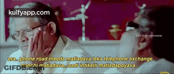 Two Men Talking At Table In Movie Scene GIF
