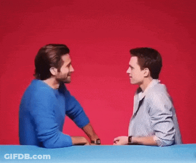 Two Men Talking At Table GIF