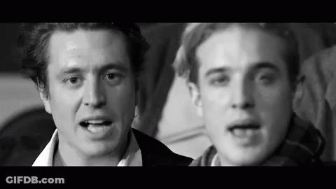 Two Men Talking In Black And White Photo GIF