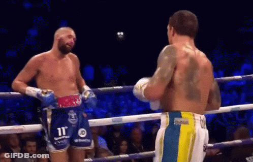 Two Men Talking In Boxing Ring, One With Back Tattoo GIF