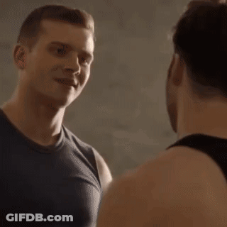 Two Men Talking In Dark Room GIF