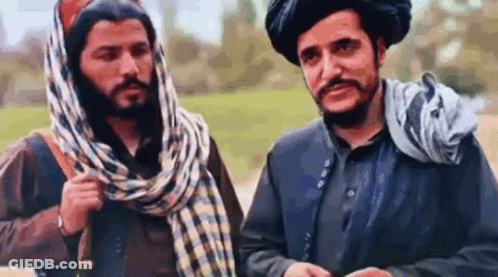 Two Men Talking In Field GIF