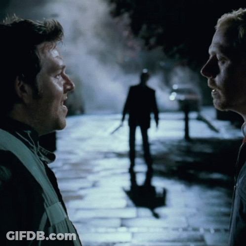 Two Men Talking In Front Of Man Silhouette GIF