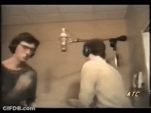 Two Men Talking In Front Of Microphone ATC GIF