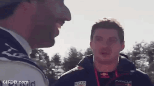 Two Men Talking In Front Of Tree GIF
