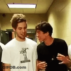 Two Men Talking In Hallway GIF