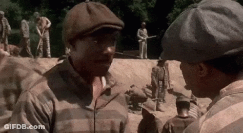Two Men Talking In Prison Yard GIF