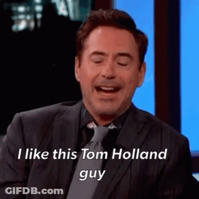 Two Men Talking One In Denim Jacket And Yellow Turtleneck GIF