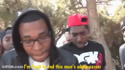 Two Men Talking, One In Hoodie And YCK Shirt GIF