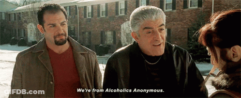Two Men Talking To Woman By Brick Building GIF