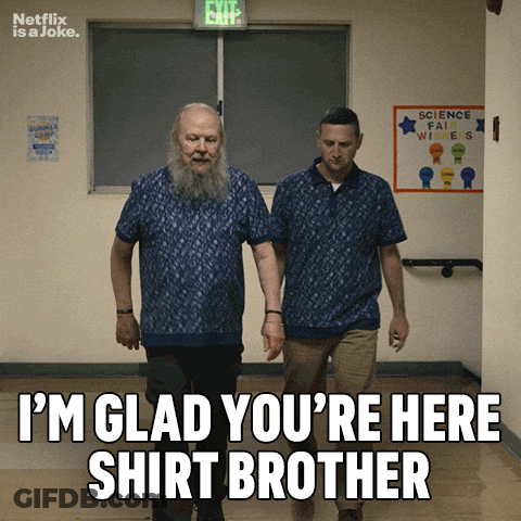 Two Men Walking Down A Hallway With A Sign That Says Science Fair Winners On It GIF