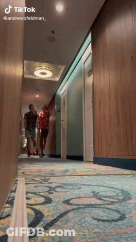 Two Men Walking Down A Hallway With A Tiktok Watermark On The Bottom GIF