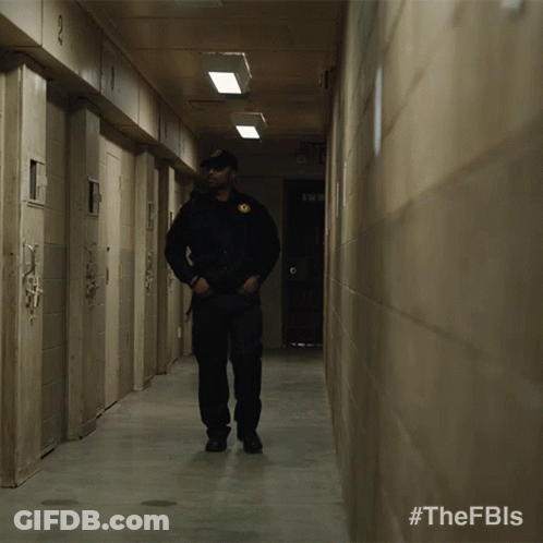 Two Men Walking Down A Hallway With #Thefbls On The Bottom GIF
