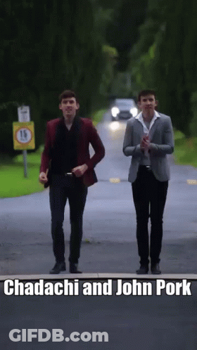 Two Men Walking Down A Road With The Words Chadachi And John Pork Written On The Bottom GIF