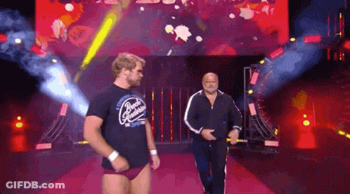 Two Men Walking Down Red Carpet In Front Of Screen GIF