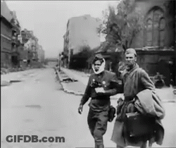 Two Men Walking Down Street GIF