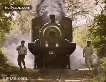 Two Men Walking In Front Of A Train GIF