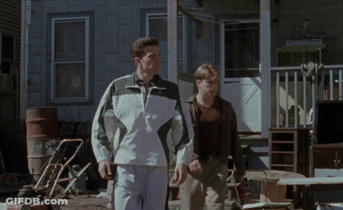 Two Men Walking In Front Of Lawn Mower GIF