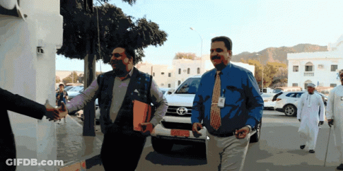 Two Men Walking In Front Of Toyota SGV GIF
