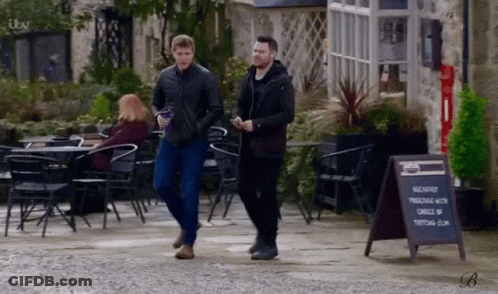 Two Men Walking Next To Breakfast Sign GIF