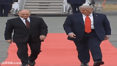 Two Men Walking On Red Carpet, One In Red Tie GIF