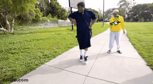 Two Men Walking One Wearing Florida Yellow Shirt GIF