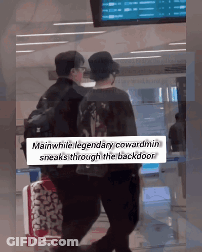 Two Men Walking Through Airport While Legendary Cowardmin Sneaks Through Backdoor GIF