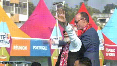 Two Men Waving In Front Of Portugal Tent GIF