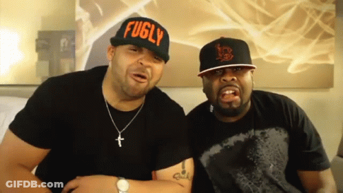 Two Men Wearing Fugly Hats Sitting Together GIF