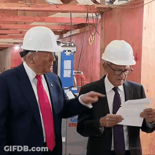 Two Men Wearing Hard Hats Are Standing In Front Of A Building That Says 270 On It GIF