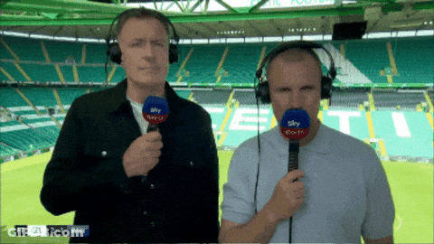 Two Men Wearing Headphones And Holding Microphones In Front Of A Stadium That Says ' Sky Sports ' On It GIF