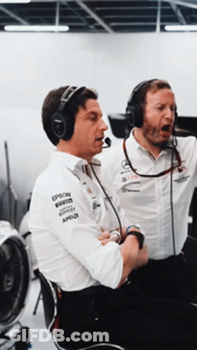 Two Men Wearing Headphones And Shirts That Say Epson Are Sitting Next To Each Other GIF
