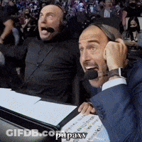 Two Men Wearing Headphones Are Sitting At A Desk And One Of Them Says " Pupaxv " GIF