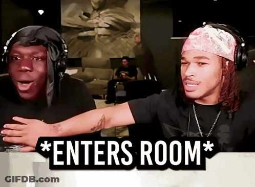 Two Men Wearing Headphones Are Sitting In Front Of A Sign That Says " Enters Room " GIF
