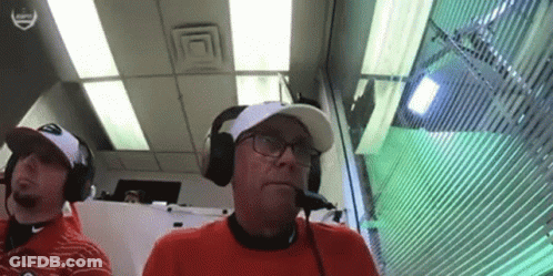 Two Men Wearing Headphones Sitting In Room GIF