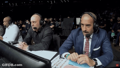 Two Men Wearing Headphones Sitting With UFC Sign GIF