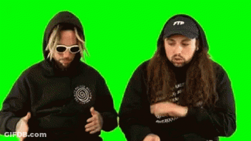Two Men Wearing Hoodies And Hats Are Dancing On A Green Screen . GIF