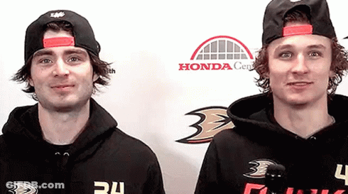 Two Men Wearing Hoodies With The Number 34 On Them Are Standing Next To Each Other GIF